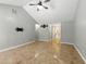 Open-concept living room with tile floors, high ceiling, and neutral decor at 314 Spring Falls Drive, Lawrenceville, GA 30045