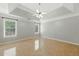 Large main bedroom featuring tray ceiling, ceiling fan and tile flooring at 314 Spring Falls Drive, Lawrenceville, GA 30045