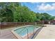 Backyard pool with a small deck and landscaping at 314 Spring Falls Drive, Lawrenceville, GA 30045