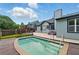Backyard pool with a small deck and greenery at 314 Spring Falls Drive, Lawrenceville, GA 30045