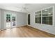 Sun room with wood floors, fan and double glass doors leading to outside at 314 Spring Falls Drive, Lawrenceville, GA 30045
