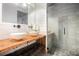 Modern bathroom featuring dual vessel sinks, wood countertop, and glass-enclosed shower at 320 Martin Luther King Jr Se Dr # 9, Atlanta, GA 30312