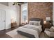 Comfortable bedroom featuring exposed brick, hardwood floors, and neutral decor at 320 Martin Luther King Jr Se Dr # 9, Atlanta, GA 30312