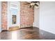 Bright bedroom features hardwood floors, exposed brick wall, and balcony access at 320 Martin Luther King Jr Se Dr # 9, Atlanta, GA 30312
