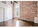 Bedroom with brick wall, high ceilings, hardwood floors, and natural light at 320 Martin Luther King Jr Se Dr # 9, Atlanta, GA 30312
