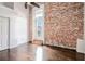 Sunlit bedroom with hardwood floors, exposed brick wall and a ceiling fan at 320 Martin Luther King Jr Se Dr # 9, Atlanta, GA 30312