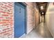 Hallway with exposed brick walls, concrete floors, and modern lighting fixtures at 320 Martin Luther King Jr Se Dr # 9, Atlanta, GA 30312