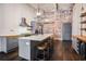 Open kitchen with a large island, industrial lighting, and a brick accent wall at 320 Martin Luther King Jr Se Dr # 9, Atlanta, GA 30312