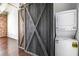Convenient laundry area with stacked washer and dryer adjacent to sliding barn door at 320 Martin Luther King Jr Se Dr # 9, Atlanta, GA 30312
