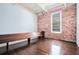 Cozy living room features hardwood floors, exposed brick wall, and natural light from window at 320 Martin Luther King Jr Se Dr # 9, Atlanta, GA 30312