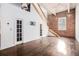 Open-concept living room with hardwood floors, brick wall, high ceilings, and staircase at 320 Martin Luther King Jr Se Dr # 9, Atlanta, GA 30312