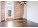 This living room features hardwood floors, an exposed brick wall, and a door to the outside at 320 Martin Luther King Jr Se Dr # 9, Atlanta, GA 30312