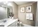 Modern bathroom with a sleek vanity, framed art, and a shower featuring contemporary gray tiling at 3351 Orwell Way # 2301, Cumming, GA 30041