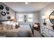 Cozy bedroom with neutral tones, featuring two windows, decorative wall art, and soft, inviting bedding at 3351 Orwell Way # 2301, Cumming, GA 30041