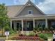 Community clubhouse surrounded by colorful flowering plants and well-manicured landscaping at 3351 Orwell Way # 2301, Cumming, GA 30041