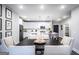 Bright dining area showcases a table setting with a view to the modern kitchen and white cabinetry at 3351 Orwell Way # 2301, Cumming, GA 30041
