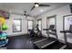 Well-lit home gym with modern equipment, windows, and ceiling fans for a complete workout at 3351 Orwell Way # 2301, Cumming, GA 30041