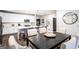 Open concept kitchen with white cabinets, stainless steel appliances, and eat-in island with modern dining area at 3351 Orwell Way # 2301, Cumming, GA 30041