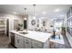 Open-concept space featuring a modern kitchen island with dining area and a view into the bright living area at 3351 Orwell Way # 2301, Cumming, GA 30041