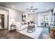 Bright living room features a ceiling fan, modern furnishings, and access to a private balcony at 3351 Orwell Way # 2301, Cumming, GA 30041