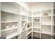 Walk-in pantry with white shelves to store plenty of snacks, drinks, and kitchen essentials at 3351 Orwell Way # 2301, Cumming, GA 30041