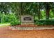 Stone 'Whisper Walk' sign surrounded by lush greenery and landscaping at 3770 Wake Robin Way, Cumming, GA 30028