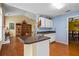 Bright kitchen with a peninsula island, white cabinets and stainless steel sink at 3770 Wake Robin Way, Cumming, GA 30028
