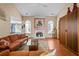 Bright living room with a fireplace, hardwood floors, and large windows at 3770 Wake Robin Way, Cumming, GA 30028