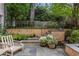 Serene back patio with stone steps and potted flowers perfect for outdoor living and entertaining at 92 Old Ivy Ne Rd # 6, Atlanta, GA 30342