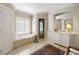Bright bathroom with a soaking tub, plantation shutters, vanity, and tile flooring at 92 Old Ivy Ne Rd # 6, Atlanta, GA 30342