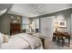 Comfortable bedroom with a ceiling fan, dresser, desk, and a large window offering ample natural light at 92 Old Ivy Ne Rd # 6, Atlanta, GA 30342