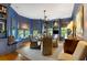 Stylish dining room with custom blue millwork, window seat and contemporary chandelier at 92 Old Ivy Ne Rd # 6, Atlanta, GA 30342
