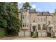 Charming townhome with brick facade, multiple dormers, and inviting front entrances at 92 Old Ivy Ne Rd # 6, Atlanta, GA 30342