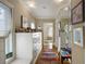 Hallway features hardwood floors, storage, and decorative art leading into the light-filled bathroom at 92 Old Ivy Ne Rd # 6, Atlanta, GA 30342