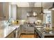 Open kitchen design with a stone backsplash, stainless steel range hood, and central island at 92 Old Ivy Ne Rd # 6, Atlanta, GA 30342
