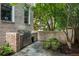 Outdoor kitchen featuring a built-in grill and stainless steel storage, complemented by brick accents and potted plants at 92 Old Ivy Ne Rd # 6, Atlanta, GA 30342