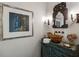 Unique powder room featuring a carved vanity with copper sink, decorative mirror, and wall sconces at 92 Old Ivy Ne Rd # 6, Atlanta, GA 30342