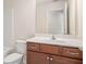 Bathroom featuring a vanity with wood cabinets, a white countertop, and a large mirror at 252 Stone Park Dr, Woodstock, GA 30188