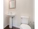 Powder room with pedestal sink, decorative mirror, and toilet at 252 Stone Park Dr, Woodstock, GA 30188