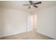 Bright bedroom featuring a ceiling fan, neutral carpet, and an open doorway at 252 Stone Park Dr, Woodstock, GA 30188