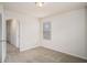 Cozy bedroom with neutral carpet, a window with blinds, and a doorway to another room at 252 Stone Park Dr, Woodstock, GA 30188