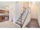 Inviting entryway with staircase, hardwood floors, and view into the kitchen at 252 Stone Park Dr, Woodstock, GA 30188