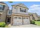 Attractive townhome featuring a stone facade, two-car garage, and inviting entrance at 252 Stone Park Dr, Woodstock, GA 30188