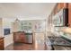 Modern kitchen with stainless steel appliances, granite countertops, and dark wood cabinets overlooking the living room at 252 Stone Park Dr, Woodstock, GA 30188