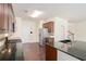 Bright kitchen with stainless steel appliances, dark wood cabinets, granite countertops, and hardwood floors at 252 Stone Park Dr, Woodstock, GA 30188