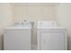 Laundry room with washer, dryer, and wire shelving at 252 Stone Park Dr, Woodstock, GA 30188