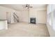 Spacious living room with fireplace, neutral carpeting, and staircase at 252 Stone Park Dr, Woodstock, GA 30188