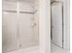 Modern shower with white tiles, decorative accent stripe, and sliding glass doors at 252 Stone Park Dr, Woodstock, GA 30188