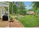 Charming backyard with a patio, lush lawn, and mature trees creating a serene outdoor space for enjoyment at 2965 Village Dr, Marietta, GA 30062