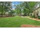 Spacious backyard showcasing a well-maintained lawn, mature trees, and a cozy seating area perfect for relaxing at 2965 Village Dr, Marietta, GA 30062